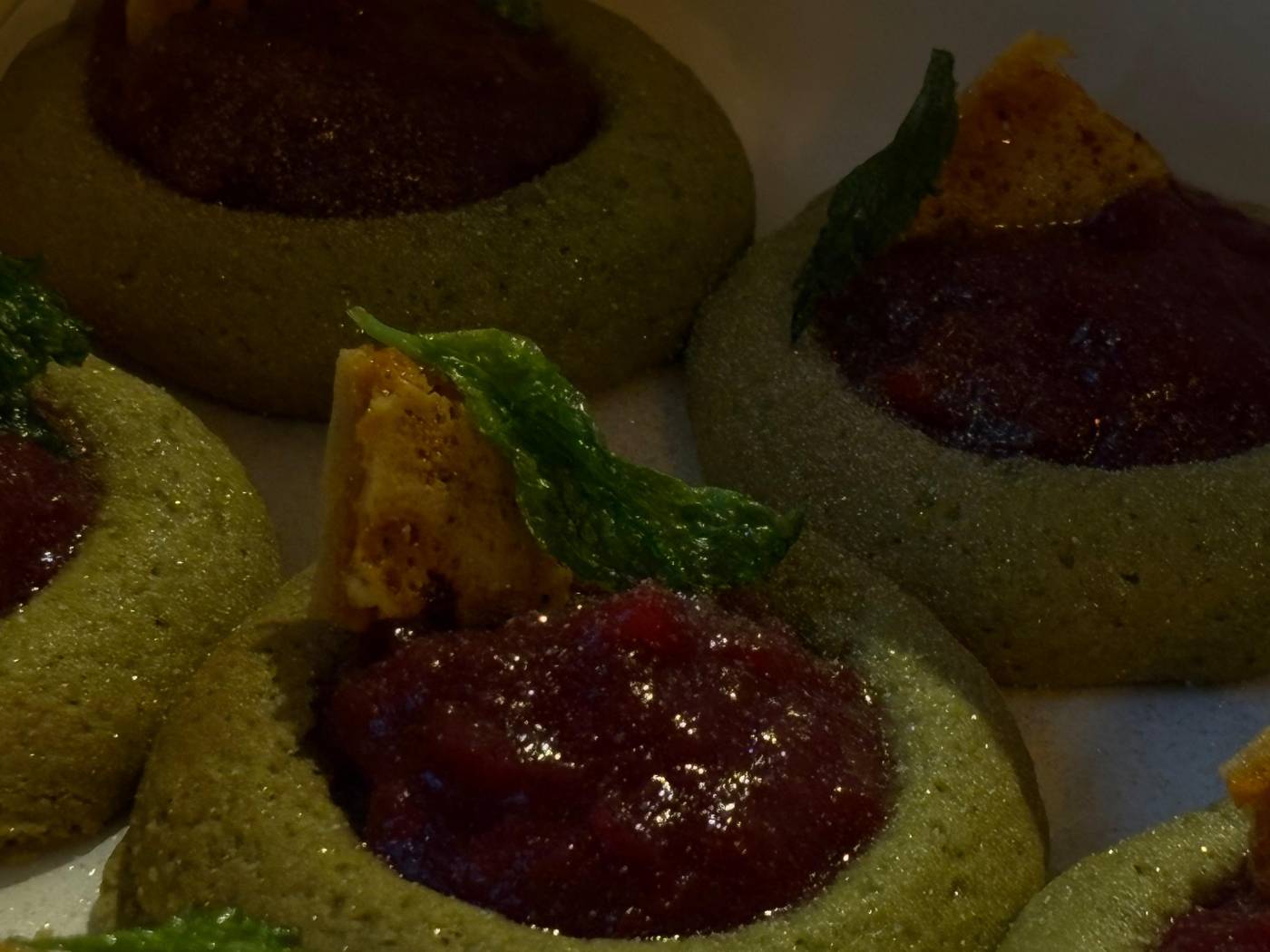 Bite-sized pastries topped with red compote