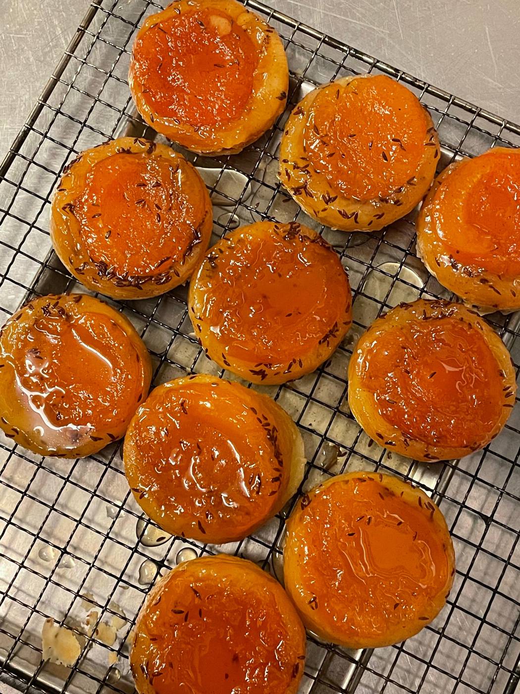 Glazed pastries cooling on a rack