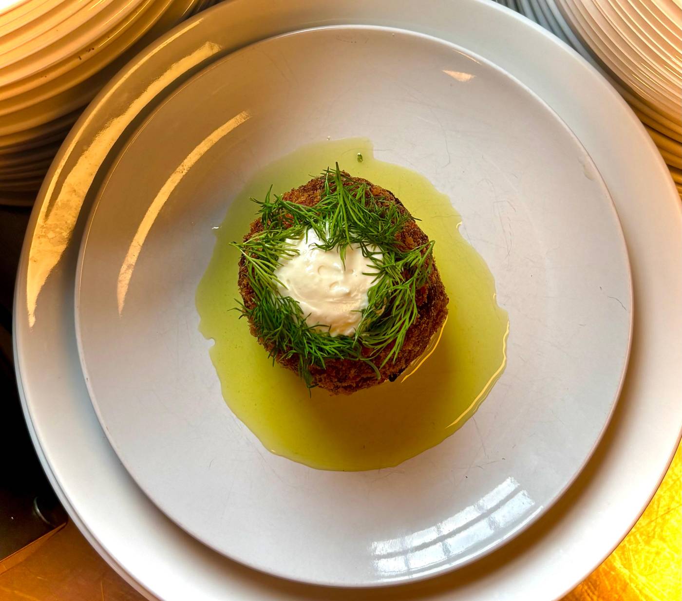 Tartare with a poached egg on a yellow-rimmed plate
